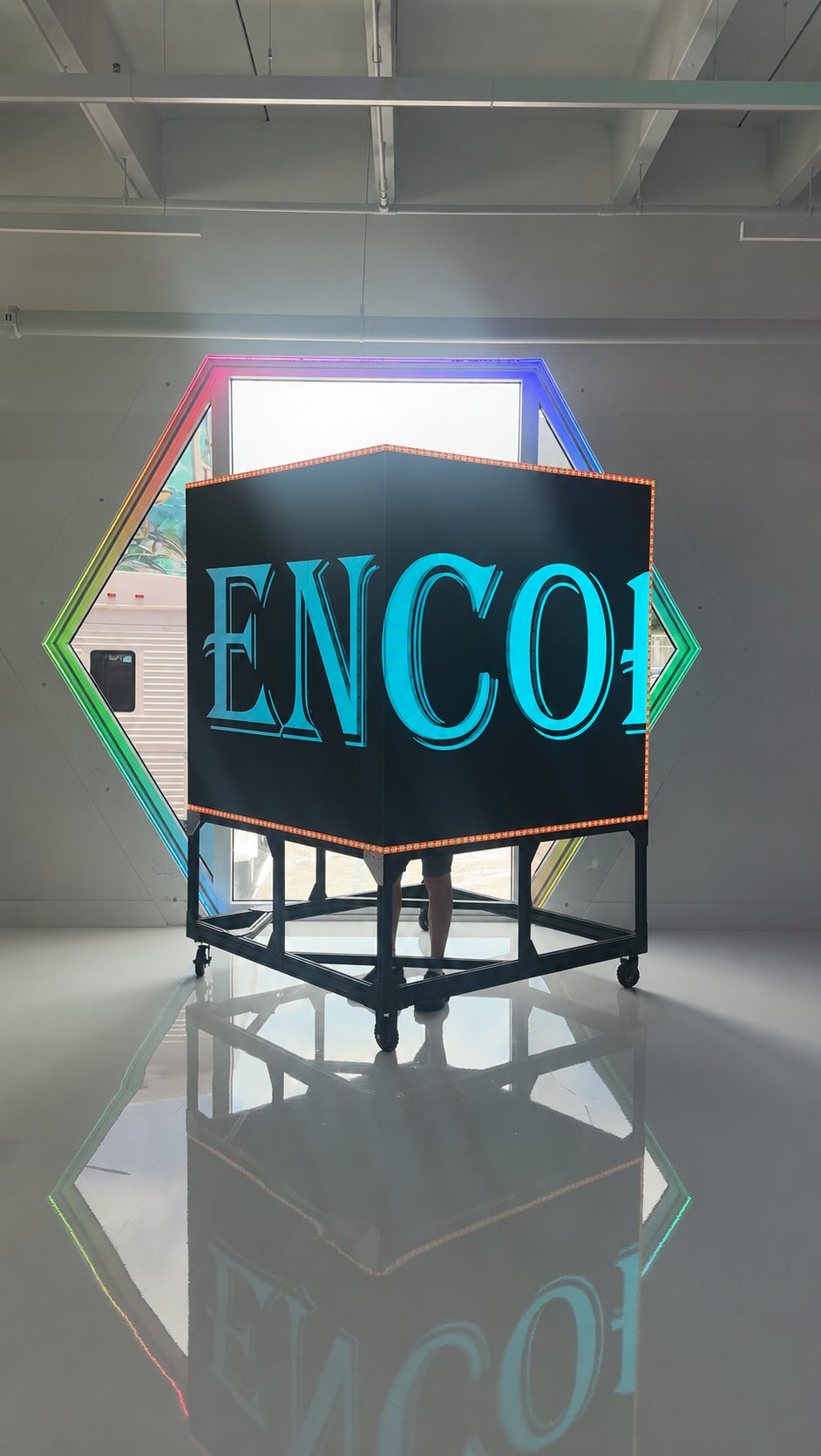 The movable digital cube repositioned in the room, showing its casters