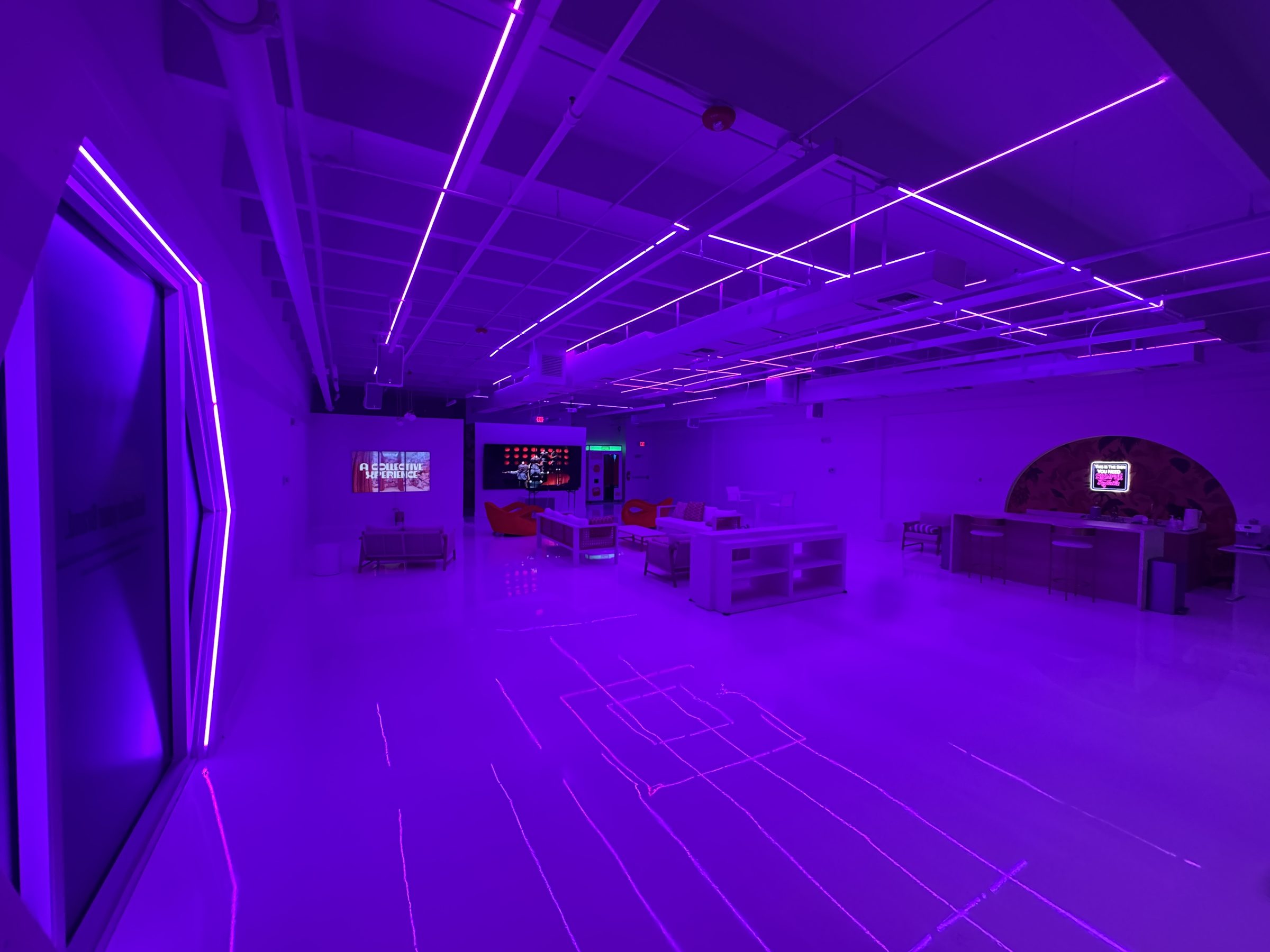Encore Wynwood interior under purple LED lighting with lounge furniture