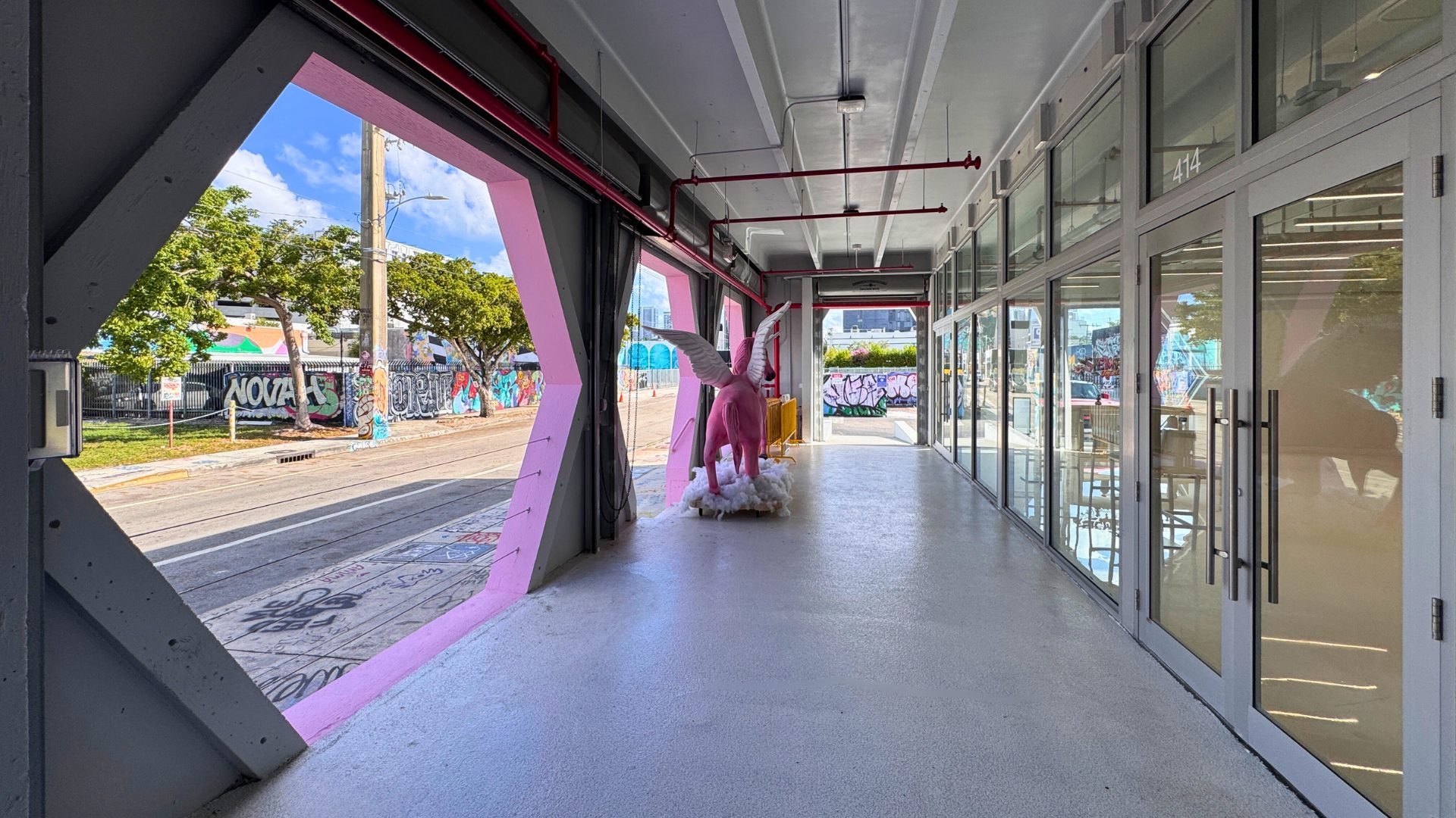The covered portico at Encore Wynwood opening onto NW 25th Street