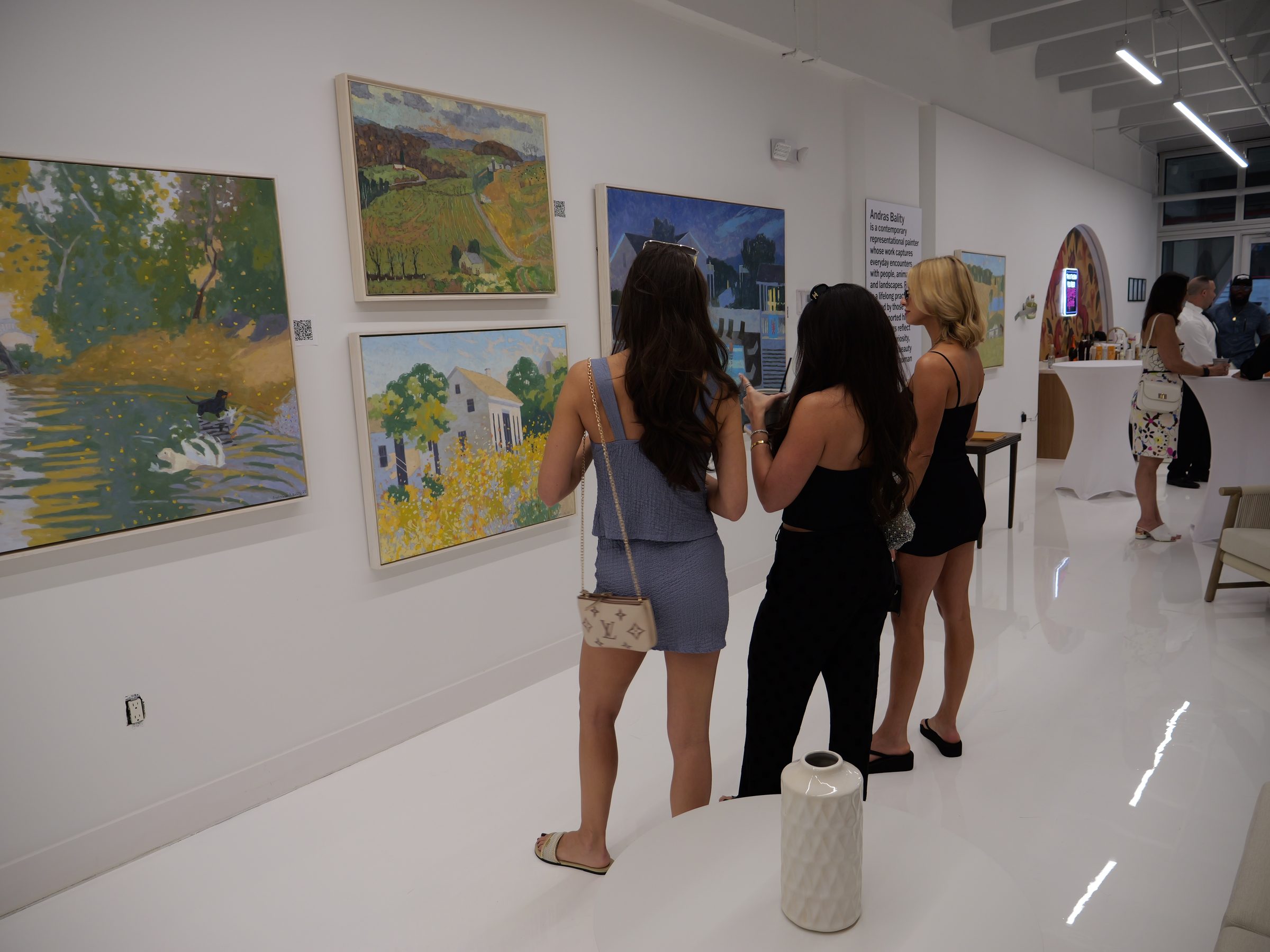 Guests viewing Andras Bality paintings at Encore Wynwood during Miami Art Week