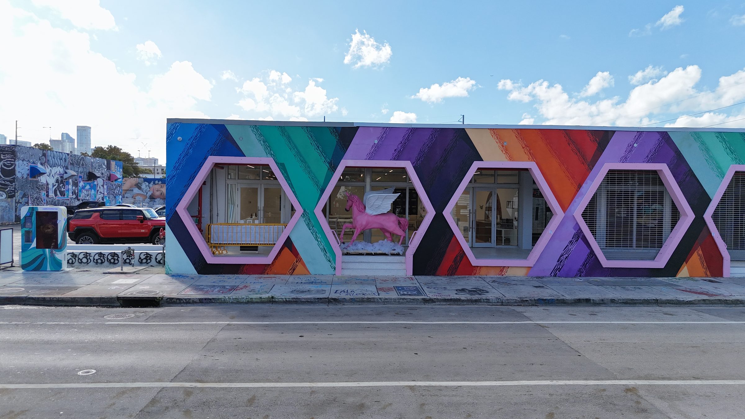 The exterior wall of Encore Wynwood on NW 25th Street with hexagonal windows and mural
